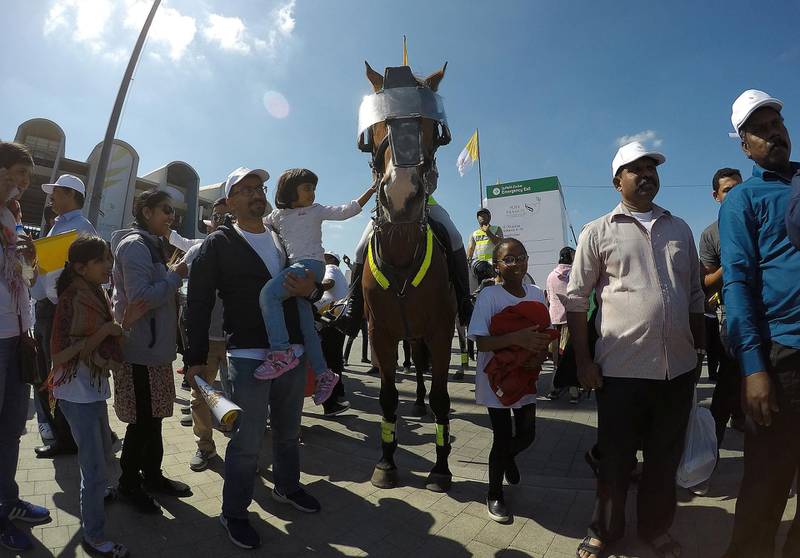ABU DHABI , UNITED ARAB EMIRATES , February 05 – 2019 :- People taking their photos with the police horse after the holy mass at the Zayed Sports City in Abu Dhabi. ( Pawan Singh / The National ) For News/Instagram/Big Picture.