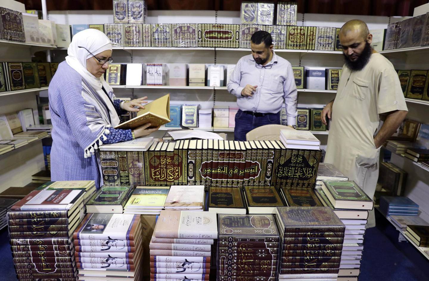 epa07871842 Visitors look at religious books presented at the 19th Amman  International Book Fair, in Amman, Jordan, 26 September 2019. The event opened its doors on 26 September and is due to last until 05 October, featuring publishers from the Arab world with their own books in Arabic and English as well as non-Arabic publications they import. The 19th edition's guest of honor is Tunisia.  EPA-EFE/AMEL PAIN *** Local Caption *** 55498024