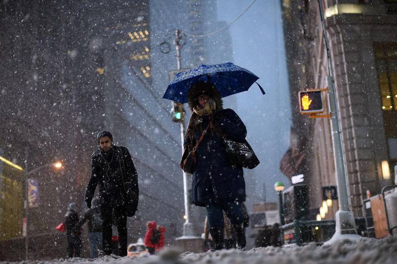 Commuters make their way in New York’s Times Square during the Juno snowstorm. Janua Jewel Samad / AFP