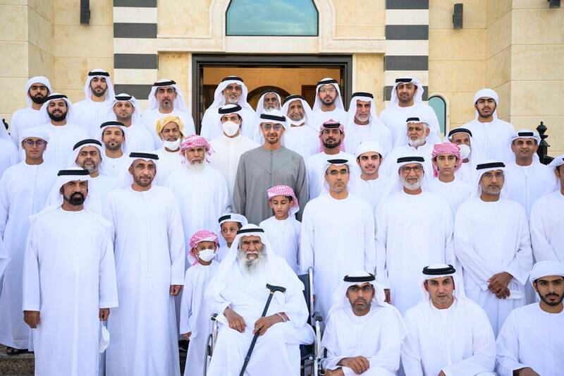 President Sheikh Mohamed stands for a photograph during a visit to the home of Saif Muftah Al Neyadi (centre R), along with Sheikh Mansour bin Zayed, Deputy Prime Minister and Minister of the Presidential Court. All photos: UAE Presidential Court 