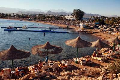Visitors relax on the beach in the Red Sea resort town of Sharm El Sheikh, Egypt. Getty Images
