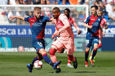 epa07503922 FC Barcelona's Kevin-Prince Boateng (R) in action against SD Huesca's Jorge Pulido (L) during the Spanish LaLiga soccer match between SD Huesca and FC Barcelona at El Alcoraz stadium in Huesca, Aragon, northern Spain, 13 April 2019.  EPA/ELENA MUNOZ