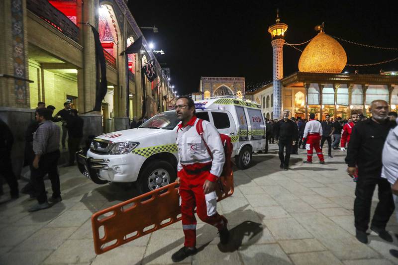 A medic carries a stretcher at Shah Cheragh shrine in Shiraz, Iran. AP