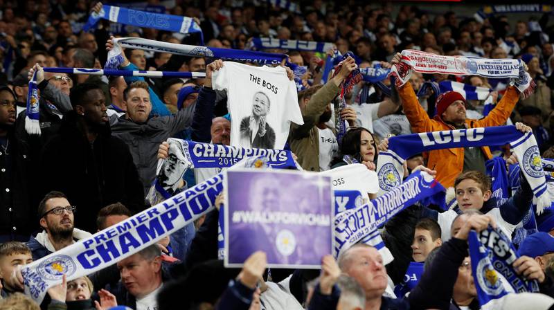 Cardiff City v Leicester City - Cardiff City Stadium, Cardiff, Britain - Leicester City fans celebrate after Demarai Gray scores their first goal and hold signs in remembrance of Vichai Srivaddhanaprabha, late chairman of Leicester City Football Club. Reuters