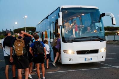 Italian, other European and US citizens evacuated from Niger after the military coup board a bus after landing at Rome's Ciampino Airport. Reuters