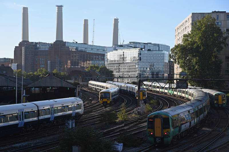 Passenger trains pass Battersea Power Station, a former electricity plant in London that has been converted into luxury residential, retail and commercial premises. Reuters