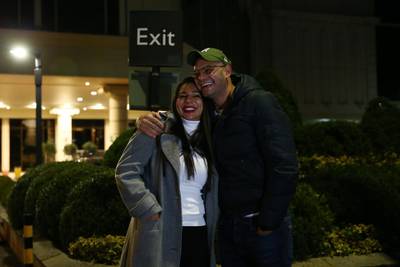 Wagner Araujo and his wife Elaine pose for the press as they leave the Radisson Blu hotel after completing their quarantine period. Getty Images