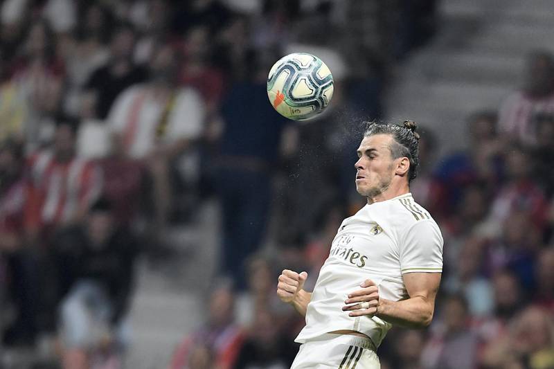Real Madrid's Welsh forward Gareth Bale jumps for the ball during the Spanish league football match between Club Atletico de Madrid and Real Madrid CF at the Wanda Metropolitano stadium in Madrid on September 28, 2019. (Photo by OSCAR DEL POZO / AFP)