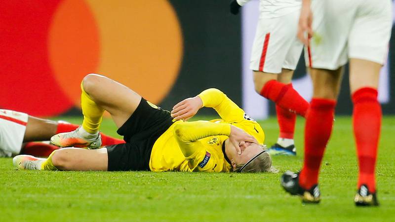Dortmund's Norwegian forward Erling Braut Haaland lays on the ground following a collosion. AFP