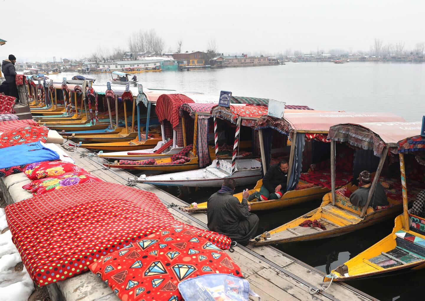 Kashmiri boatmen wait for tourists on the banks Dal Lake in Srinagar, the summer capital of Indian Kashmir. EPA