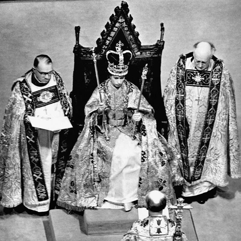 Queen Elizabeth wearing the St Edward Crown and carrying the sceptre and rod after her coronation. 
