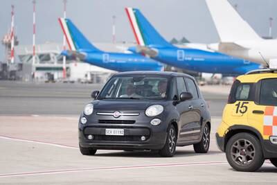 Pope Francis, left, arrives in a car at the airport in Rome, for his flight to Marseille. EPA