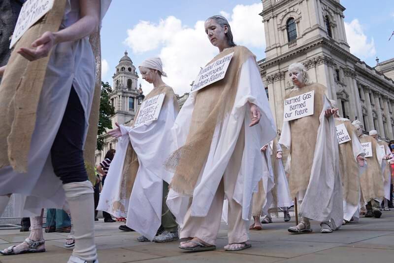 Members of Extinction Rebellion donned robes to demonstrate in Parliament Square. AP