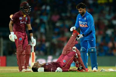 India wicketkeeper Rishabh Pant helps West Indies' Shimron Hetmyer duringa bout of cramps in Chennai. AFP