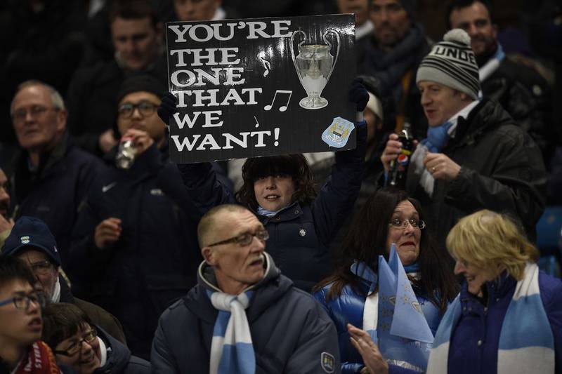 A Manchester City fan holds up a sign as they wait for kick off at Tuesday night's Champions League last 16 match against Barcelona. Lluis Gene / AFP