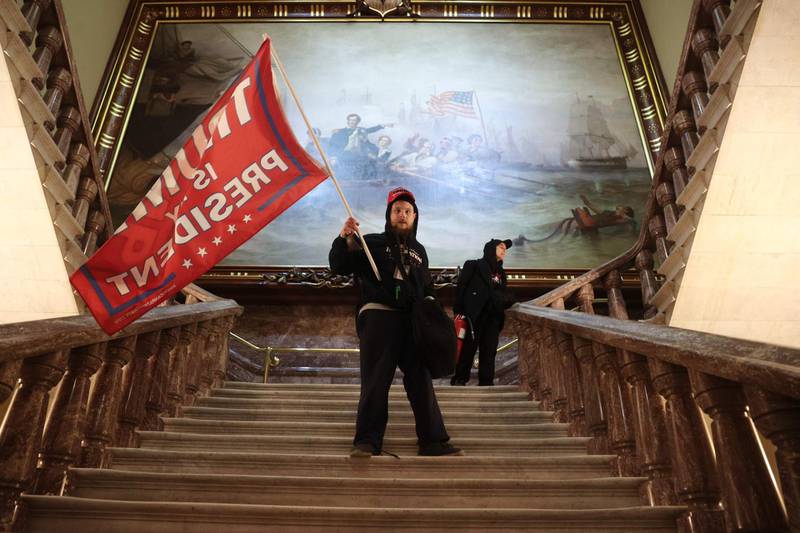 A protester holds a Trump flag inside the US Capitol Building near the Senate Chamber. AFP