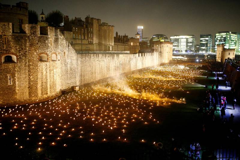 The moat of the Tower of London is seen filled with thousands of lit torches as part of the installation 'Beyond the Deepening Shadow', in London. Reuters