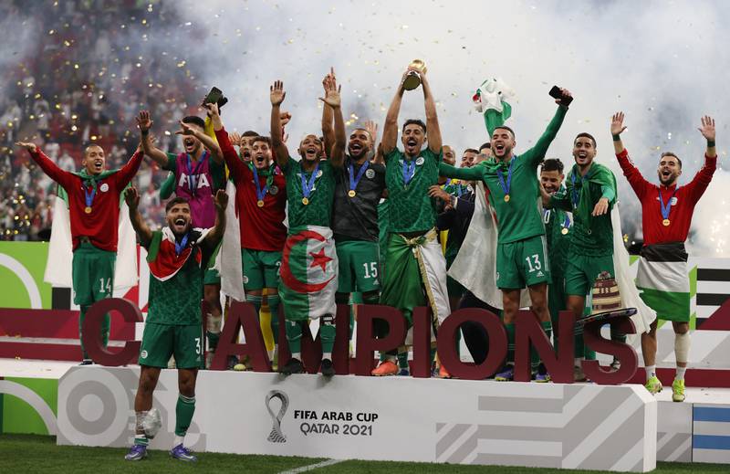 Algeria's Baghdad Bounedjah lifts the trophy as they celebrate winning the Arab Cup. Image: Reuters
