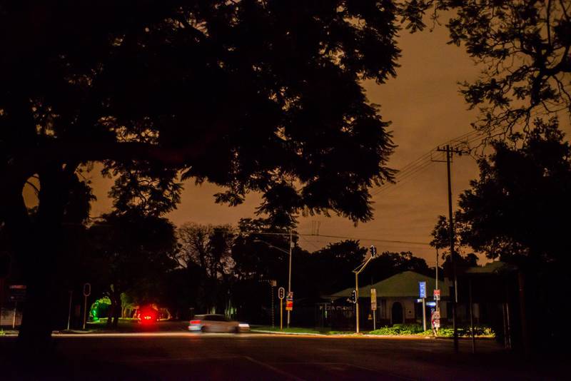 A vehicle passes across a highway intersection on an unlit street after a load-shedding power outage switches off traffic signals and street lights in Pretoria, South Africa, on Wednesday, Feb. 13, 2019. Eskom Holdings SOC Ltd. cut supplies for the fifth day on Thursday and warned its power generation system remains "vulnerable." Photographer: Waldo Swiegers/Bloomberg