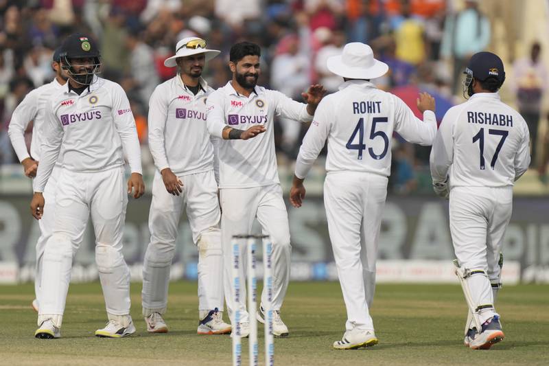 India's Ravindra Jadeja, centre, celebrates with his teammates the dismissal of Sri Lanka's Lasith Embuldeniya in the second innings on the third day of the first Test in Mohali on Sunday, March 6, 2022. AP