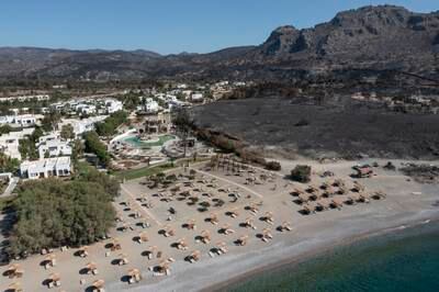 An area ravaged by wildfire next to a hotel on the coastline in Lardos, Rhodes, Greece. Getty Images