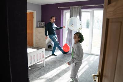 Roman Starkov plays with nephew Alikhan as they settle into their new home in Caldecote, near Cambridge, after they fled Kharkiv. PA