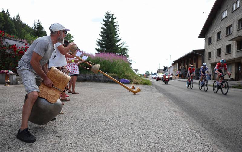 Spectators ring cow bells and play alpine horns (or Swiss Alphorns) during Stage 8. AFP