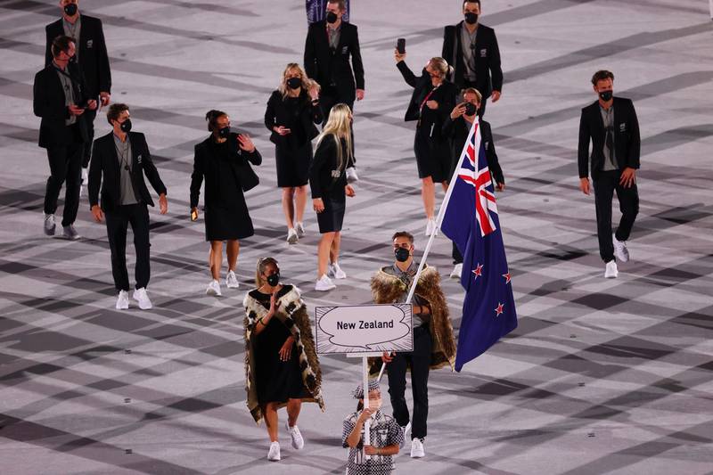 Flag bearers Hamish Bond of New Zealand and Sarah Hirini of New Zealand lead their contingent.