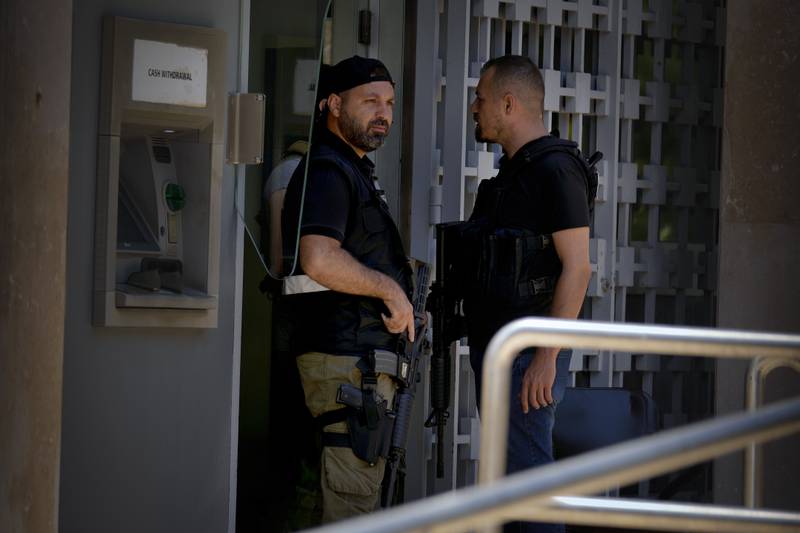 Lebanese security personnel stand guard at the entrance of the central bank during the raid. AP