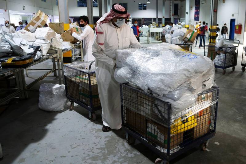 A Saudi employee sorts out boxes at the warehouse of Naqel Company Express in Riyadh, Saudi Arabia. Reuters