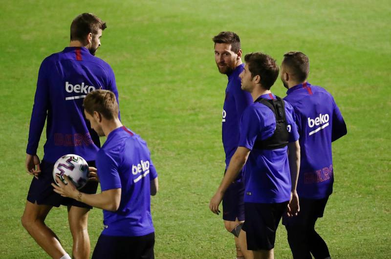 Lionel Messi with his Barcelona teammates. Reuters