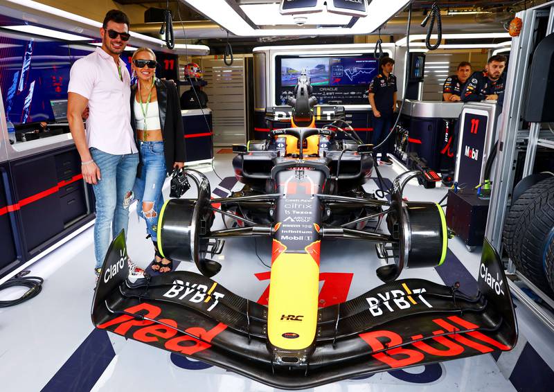 Mary Fitzgerald and 'Selling Sunset' star Romain Bonnet pose for a photo in the Red Bull Racing garage. AFP