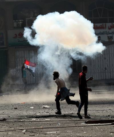 Iraqi security forces fire tear gas during clashes with anti-government protesters, in Baghdad, Iraq. AP Photo