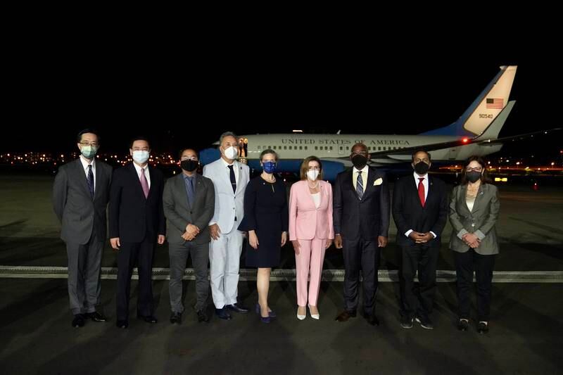 Ms Pelosi poses for a group photo with Mr Wu and other officials on the tarmac. EPA / Taiwan Ministry of Foreign Affairs 