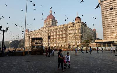 IndiancChildren wait for the start of a skating rally at the promenade outside the Taj Mahal Palace and hotel in Mumbai on November 26, 2014, in memory of those who lost their lives on the sixth anniversary of the November 2008 terror attacks. A total of 166 people were killed and more than 300 others were injured when 10 heavily-armed Islamist militants stormed the city on November 26, 2008, attacking a number of sites, including the city's main railway station, two luxury hotels, a popular tourist restaurant and a Jewish centre. AFP PHOTO/ INDRANIL MUKHERJEE / AFP PHOTO / INDRANIL MUKHERJEE
