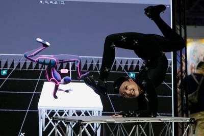 A dancer gives a demonstration using a motion-tracking device at the Game Show trade fair in Chiba, east of Tokyo. AP