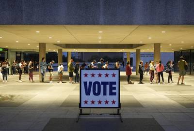 Voters wait in line at a polling station at the Lyndon B.  Johnson School of Public Affairs in Austin, Texas. AP
