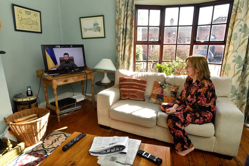 Diana Flaherty watches Mr Zelenskyy's speech at her home in Dublin. Reuters