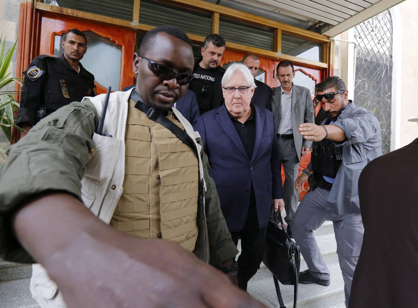 epa06812660 Bodyguards escort UN Special Envoy to Yemen Martin Griffiths (C) upon his arrival in Sana'a, Yemen, 16 June 2018. According to reports, UN Special Envoy to Yemen Martin Griffiths arrived in Sana'a for talks with Houthi representatives on the western port of Hodeida where Yemeni government forces backed by the Saudi-led coalition are battling Houthi rebels.  EPA/YAHYA ARHAB