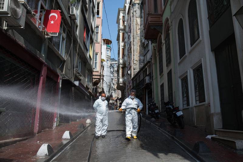Istanbul Metropolitan Municipality workers spray a street with disinfectant to prevent the spread of coronavirus in Istanbul, Turkey, on Monday, April 27, 2020. Coming off a brief recession just over a year ago, the urgency is mounting for Turkey to loosen the screws on the economy as its currency and reserves come under pressure more than a month after it introduced social-distancing measures. Photographer: Kerem Uzel/Bloomberg