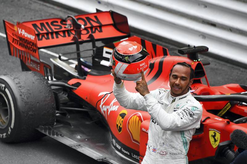 Mercedes' British driver Lewis Hamilton points at the name of late Formula One legend Niki Lauda on his helmet after winning the Monaco Formula 1 Grand Prix at the Monaco street circuit on May 26, 2019 in Monaco. (Photo by Yann COATSALIOU / AFP)