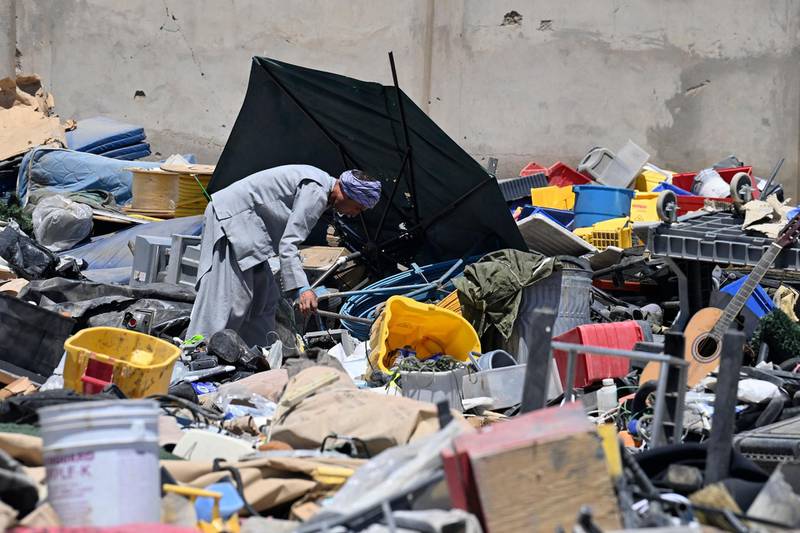 A man selects valuable items at a recycling workshop near the Bagram Air Base. AFP