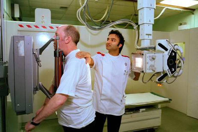 BRENTFORD,UNITED KINGDOM - APRIL 2005: David Bailey, 54, prepares for a chest X-ray with nurse Deepesh Maru in Brentford Hospital. (Photo by Tom Stoddart/Getty Images)