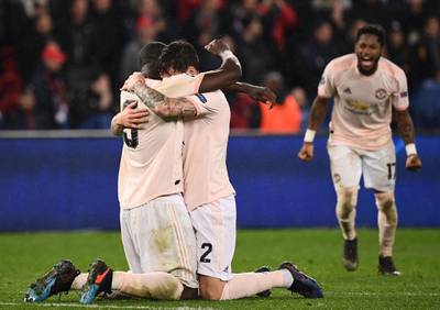 Manchester United's Brazilian midfielder Fred, and teammates Victor Lindelof, centre, and Romelu Lukaku celebrate after their 3-1 victory over Paris Saint-Germain in Paris sent United through to the Champions League quarter-finals on away goals. AFP