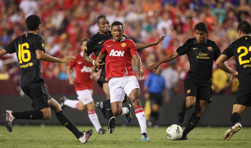 LANDOVER, MD - JULY 30:  Nani of Manchester United clashes with Seydou Keita (L) and Jonathan dos Santos of Barcelona during the pre-season friendly match between Manchester United and Barcelona as part of their pre-season tour of the USA at FedExField on July 30, 2011 in Landover, Maryland.  (Photo by Matthew Peters/Man Utd via Getty Images)