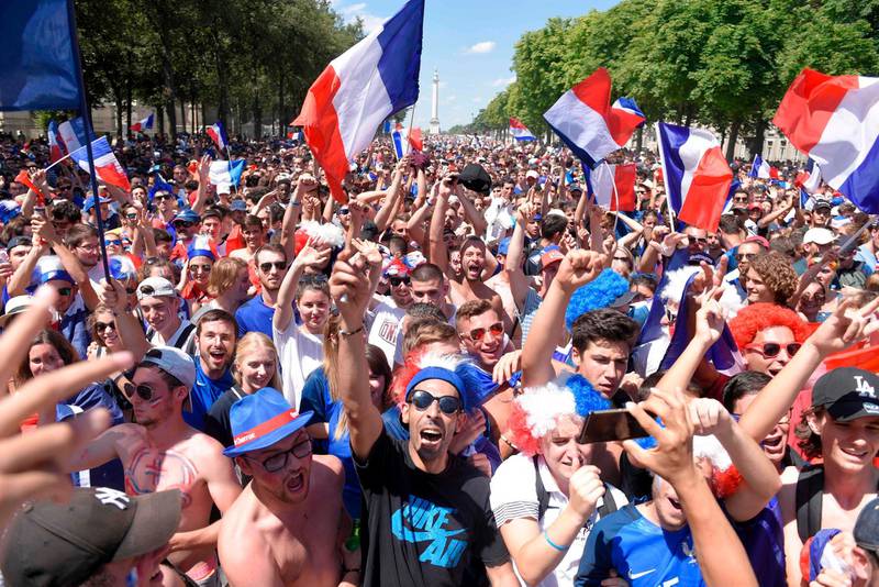 Supporters wave French flags as they wait in front of a giant screen in central Nantes. AFP