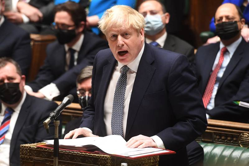 A handout photograph released by the UK Parliament shows Britain's Prime Minister Boris Johnson attending Prime Minister's Questions (PMQs) in the House of Commons in London on January 12, 202.  - UK Prime Minister Boris Johnson Wednesday apologised for attending a lockdown-breaching party held in his Downing Street garden, but deflected calls to resign as the opposition leader called him a "man without shame".  After days of dismal headlines and collapsing poll ratings, Johnson said he regarded the newly revealed boozy get-together in May 2020 as a work event for Downing Street staff. AFP PHOTO  /  Jessica Taylor  / UK Parliament