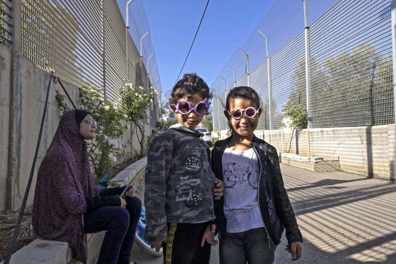 Children of the Gharib family are pictured between Israeli army barriers.