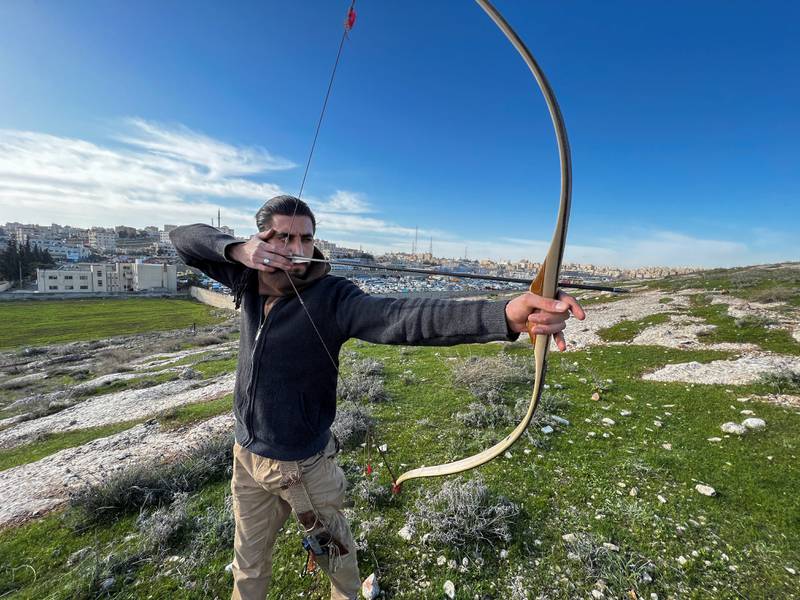 The Jordanian tests a bow and arrow in Amman.