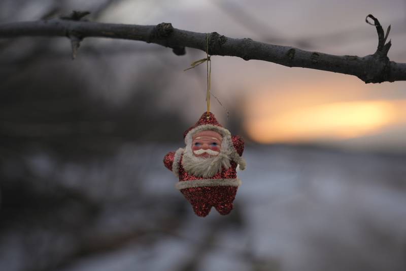 A Santa Claus Christmas decoration hangs from a tree branch outside a bunker at a frontline position outside Popasna, the Luhansk region, in eastern Ukraine, just after the war began in February. AP Photo